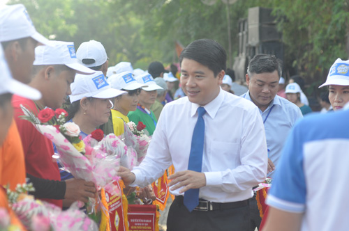 Phó Chủ tịch UBND tỉnh Trần Văn Tân tặng cờ và hoa động viên các thuyền đua trước giờ thi đấu.